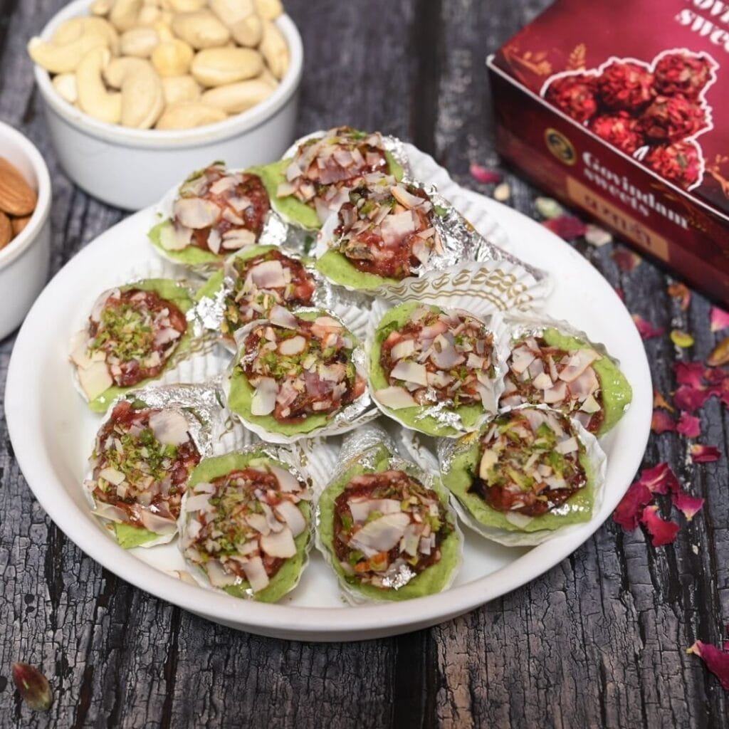 Cross-section of pista paan revealing layers of green pistachio filling with visible nut pieces