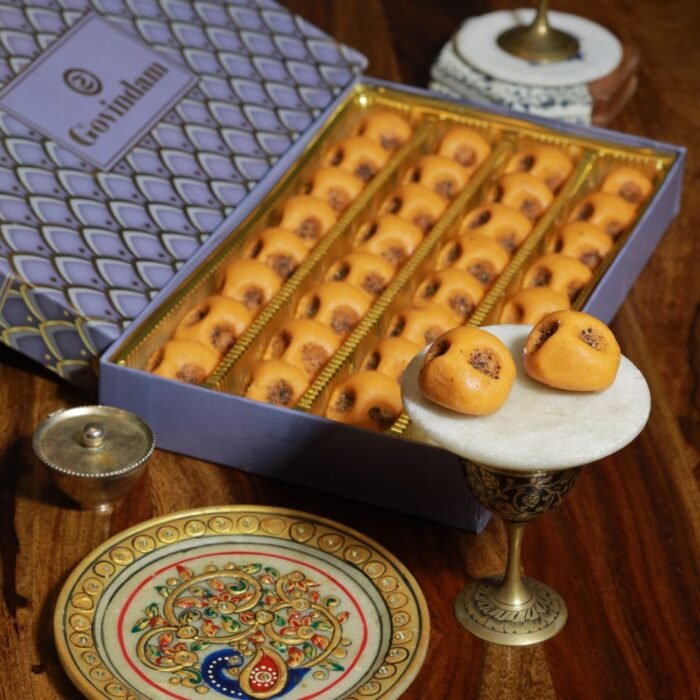 Close-up of Rajasthani peda texture showing fine grains and a rustic, crumbly surface