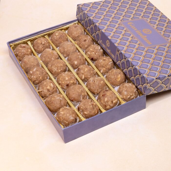 Cross-section of gond dry fruit laddu revealing dense texture with visible nut and fruit pieces