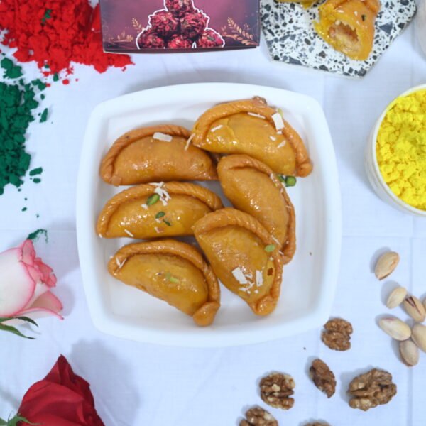 Gujiya served with a bowl of thandai for a festive treat.