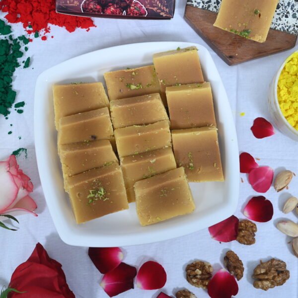 Mysore Pak pieces neatly arranged on a silver platter.