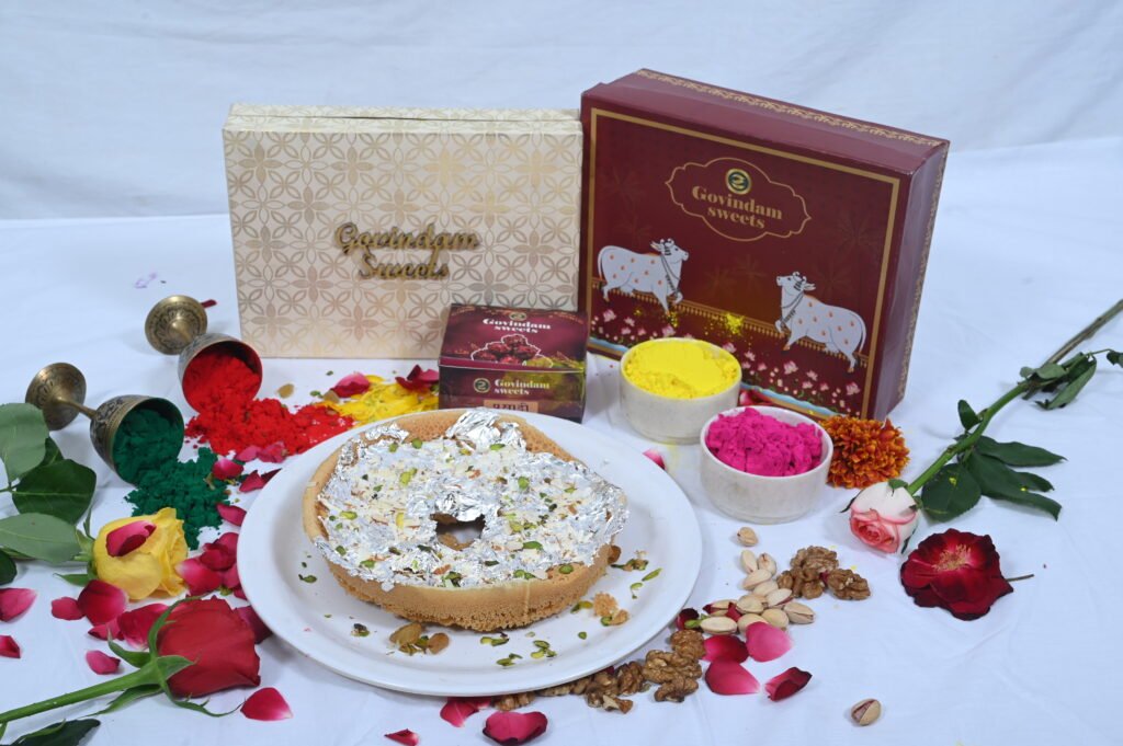 Meetha Ghewar garnished with silver leaf and rose petals.